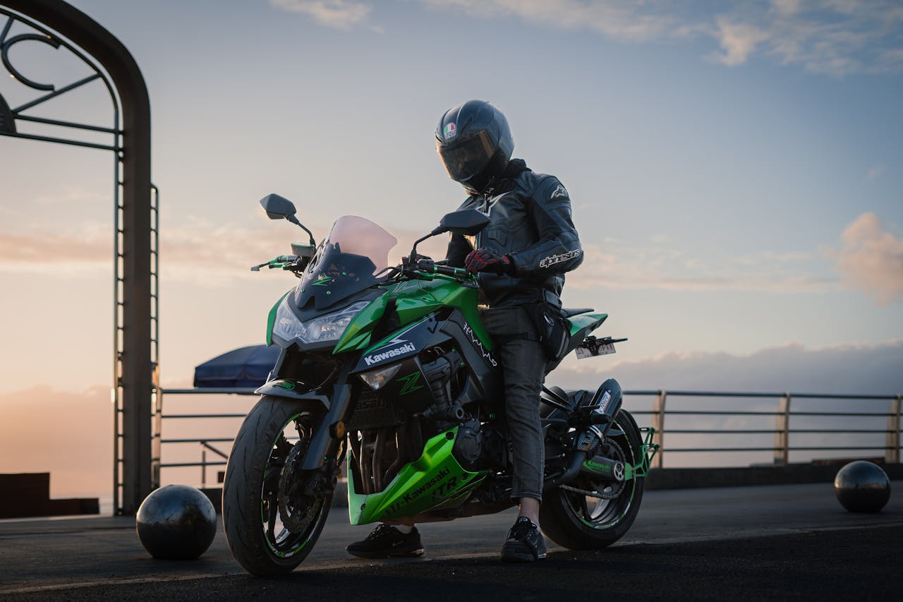 Biker on a Kawasaki Z1000 motorcycle taking a break with scenic sunset in Casablanca, Morocco.